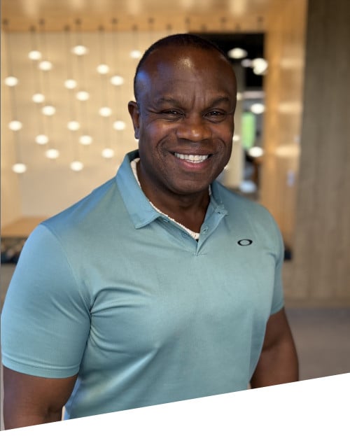Smiling man in teal polo indoors