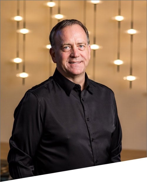 Smiling man in black shirt with modern lights