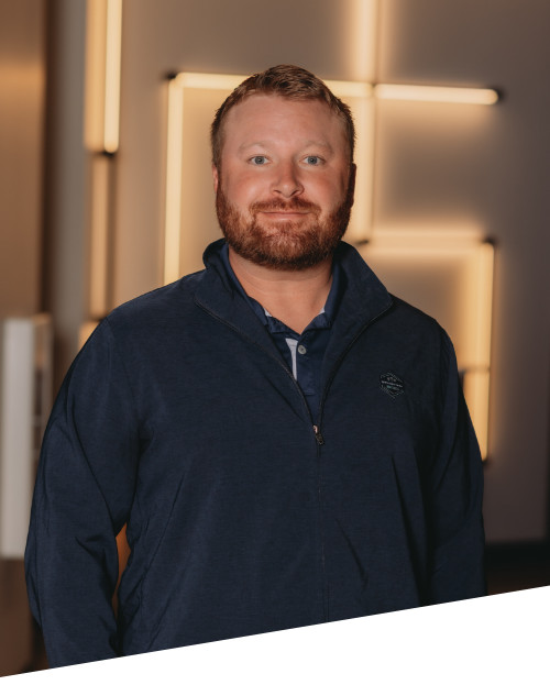 Smiling man in jacket with abstract background lighting.