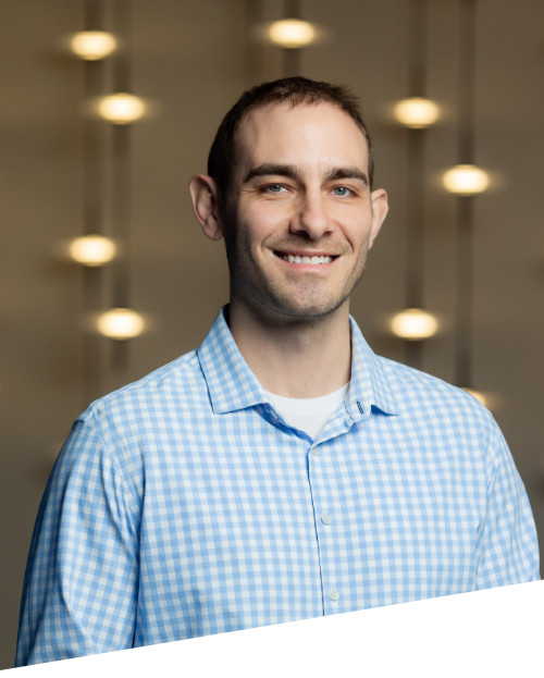 Smiling man in checkered shirt with blurred lights