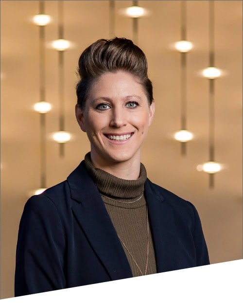 Person smiling with modern lighting background.