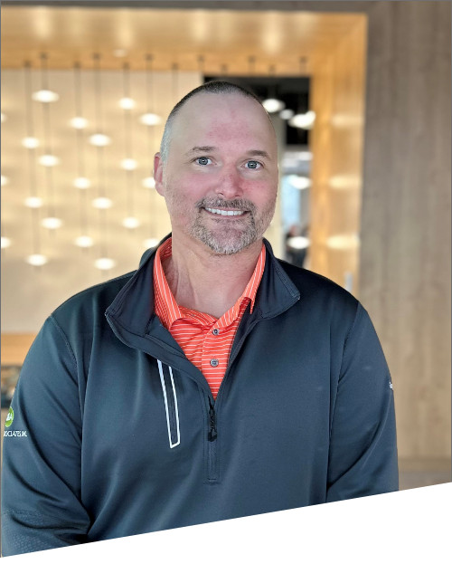 Smiling person in casual attire indoors.