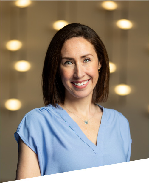 Woman smiling against blurred lights background.